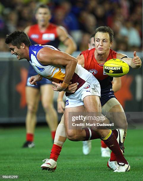 Simon Black of the Lions is tackled by Clint Bartram of the Demons during the round five AFL match between the Melbourne Demons and the Brisbane...