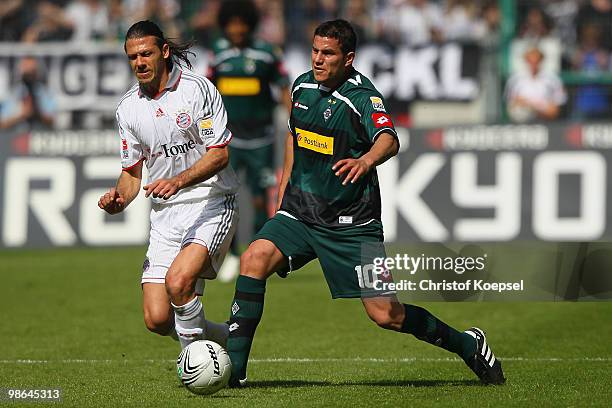 Martin Demichelis of Bayern challenges Raul Marcelo Bobadilla of Gladbach during the Bundesliga match between Borussia Moenchengladbach and FC Bayern...