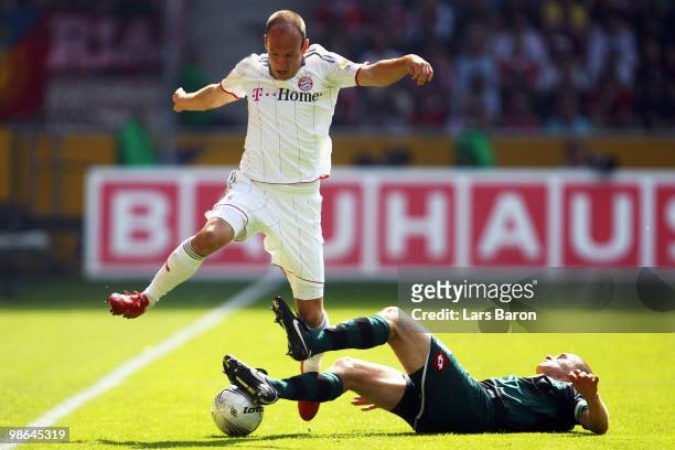 Arjen Robben of Muenchen is challenged by Filip Daems of Moenchengladbach during the Bundesliga match between Borussia Moenchengladbach and FC Bayern...