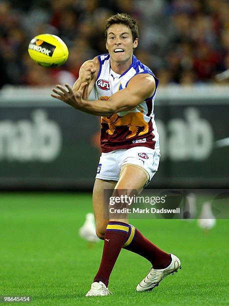 Andrew Raines of the Lions handballs to a teammate during the round five AFL match between the Melbourne Demons and the Brisbane Lions at Melbourne...