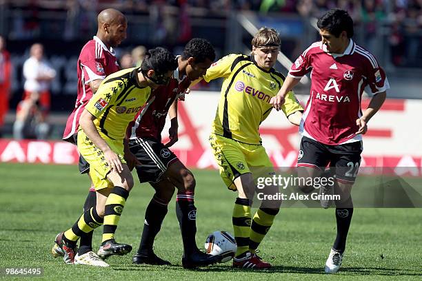 Nuri Sahin and Marcel Schmelzer of Dortmund are challenged by Mickael Tavares , Maxim Choupo-Moting and Ilkay Guendogan of Nuernberg during the...