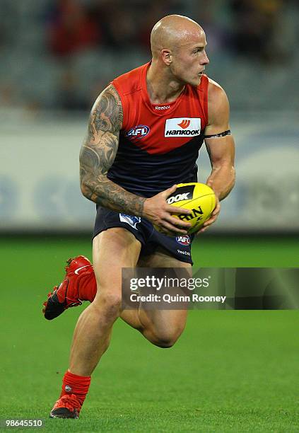 Nathan Jones of the Demons looks to pass the ball during the round five AFL match between the Melbourne Demons and the Brisbane Lions at Melbourne...