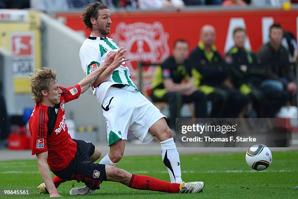 Stefan Kiessling of Leverkusen tackles Christian Schulz of Hannover during the Bundesliga match between Bayer Leverkusen and Hannover 96 at BayArena...
