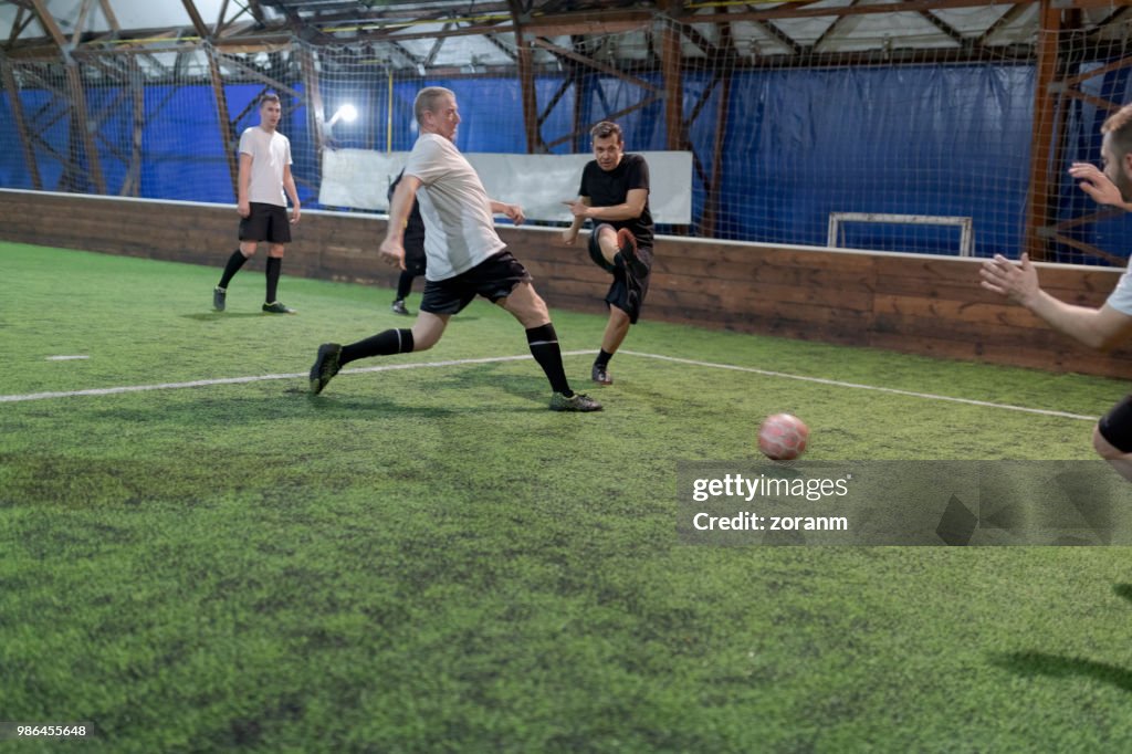 Amateur soccer player kicking ball