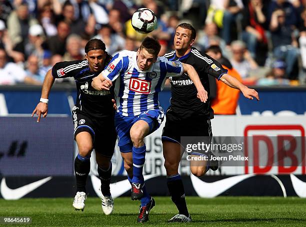 Lukasz Piszczek of Berlin and Marcelo Bordon and Lukas Schmitz of Schalke battle for the ball during the Bundesliga match between Hertha BSC Berlin...