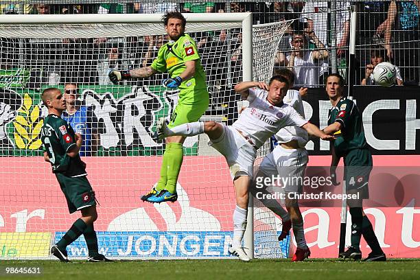 Logan Bailly of Gladbach saves the ball against Ivica Olic of Bayern during the Bundesliga match between Borussia Moenchengladbach and FC Bayern...