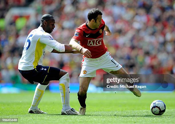 Ryan Giggs of Manchester United is challenged by Ledley King of Tottenham Hotspur during the Barclays Premier League match between Manchester United...