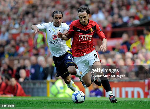 Dimitar Berbatov of Manchester United competes for the ball with Benoit Assou-Ekotto of Tottenham Hotspur during the Barclays Premier League match...