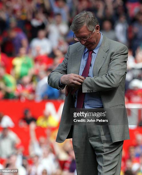 Sir Alex Ferguson of Manchester United looks at his watch during the Barclays Premier League match between Manchester United and Tottenham Hotspur at...