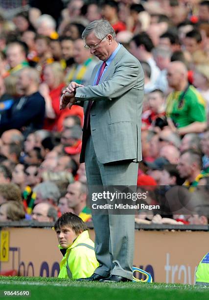 Manchester United Manager Sir Alex Ferguson checks his watch during the Barclays Premier League match between Manchester United and Tottenham Hotspur...