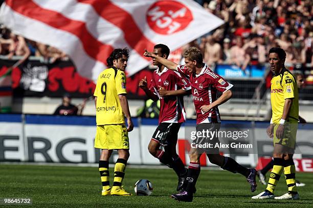 Mike Frantz of Nuernberg celebrates his team's first goal as Nelson Valdez and Lucas Barrios of Dortmund react during the Bundesliga match between 1....