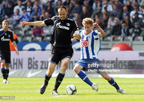 Fabian Lustenberger of Berlin battles for the ball with Heiko Westermann of Schalke during the Bundesliga match between Hertha BSC Berlin and FC...