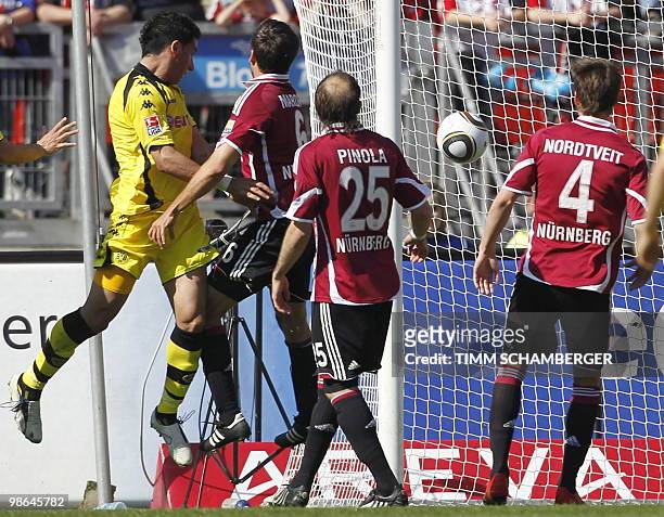Dortmund's Argentinian striker Lucas Barrios scores past Nuremberg's defender Dominic Maroh Nuremberg's Argentinian defender Javier Pinola and...