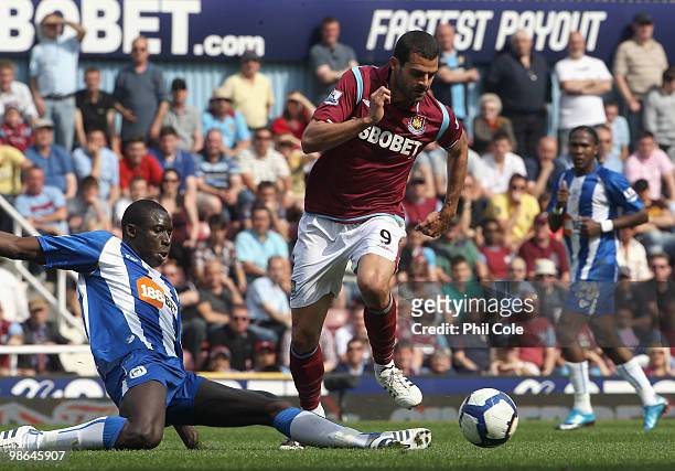 Araujo Ilan of West Ham is tackled by Mohamed Diame of Wigan during the Barclays Premier League match between West Ham United and Wigan Athletic at...