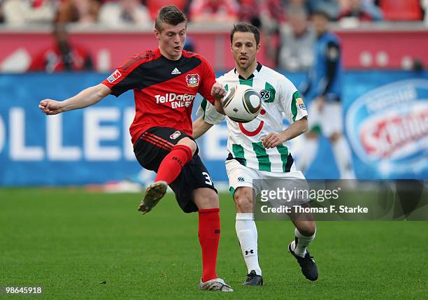 Toni Kroos of Leverkusen battles for the ball with Steven Cherundolo of Hannover during the Bundesliga match between Bayer Leverkusen and Hannover 96...