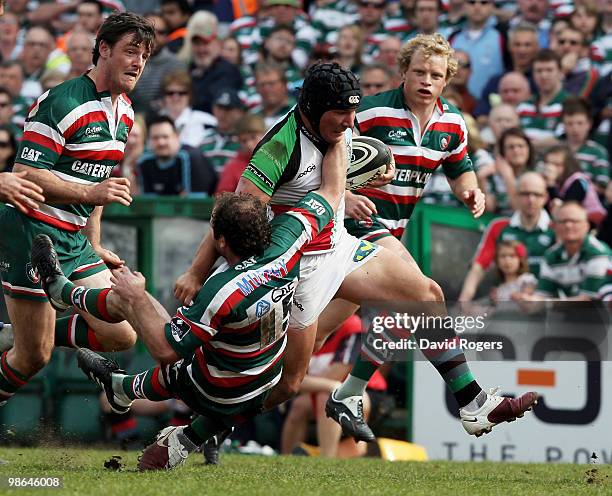 George Lowe of Harlequins is tackled by Geordan Murphy during the Guinness Premiership match between Leicester Tigers and Harlequins at Welford Road...