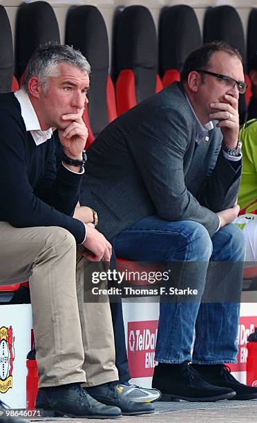 Head coach Mirko Slomka and manager Joerg Schmadtke of Hannover sit dejected on the substitutes bench during the Bundesliga match between Bayer...