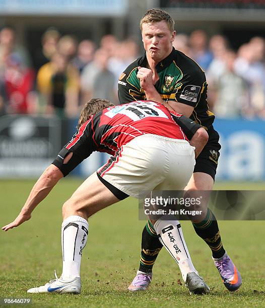 Chris Ashton of Northampton is tackled by Alex Goode of Saracens during the Guinness Premiership match between Northampton Saints and Saracens at...