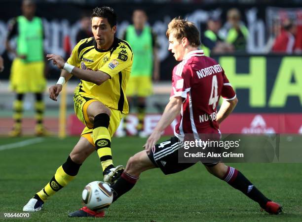 Lucas Barrios of Dortmund is challenged by Havard Nordtveit of Nuernberg during the Bundesliga match between 1. FC Nuernberg and Borussia Dortmund at...