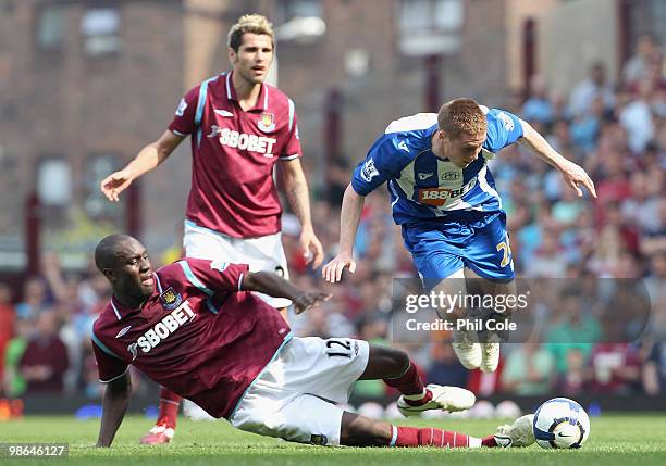 Carlton Cole of West Ham tackles James McCarthy of Wigan during the Barclays Premier League match between West Ham United and Wigan Athletic at the...
