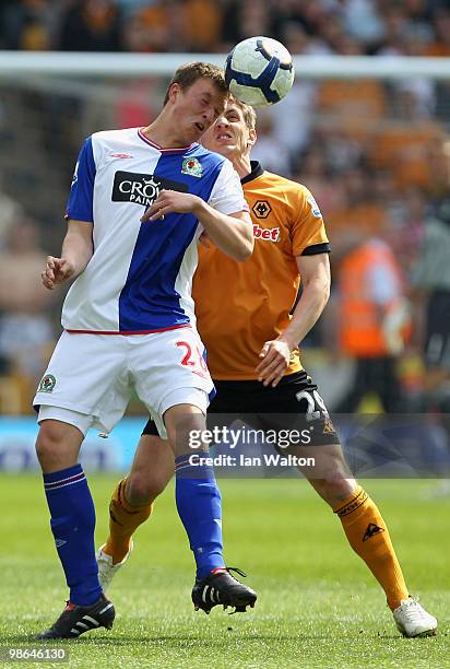 Kevin Doyle of Wolverhampton Wanderers tries to tackle Phil Jones of Blackburn Rovers during the Barclays Premier League match between Wolverhampton...