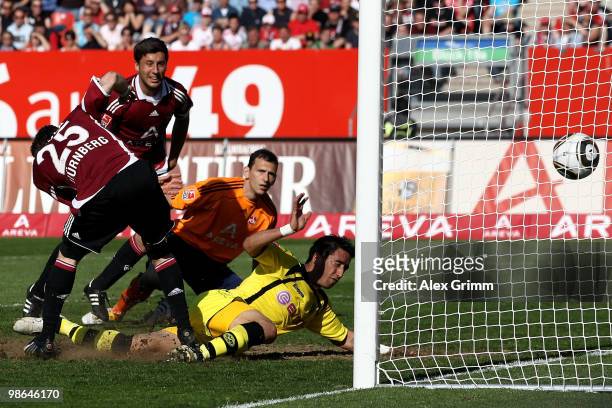 Lucas Barrios of Dortmund scores his team's third goal against goalkeeper Raphael Schaefer, Dominic Maroh and Javier Pinola of Nuernberg during the...