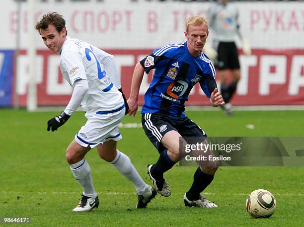 Luke Wilkshire of FC Dynamo Moscow battles for the ball with Pyotr Nemov of FC Saturn Moscow Oblast during the Russian Football League Championship...