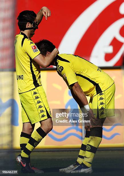 Lucas Barrios of Dortmund scores his team's third goal and celebrates with team mate Nuri Sahin during the Bundesliga match between 1. FC Nuernberg...