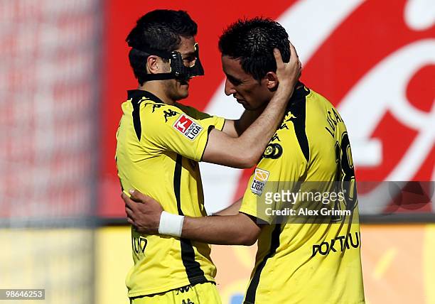 Lucas Barrios of Dortmund scores his team's third goal and celebrates with team mate Nuri Sahin during the Bundesliga match between 1. FC Nuernberg...