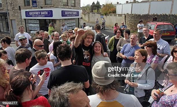Brian May, founding member of the rock band Queen, speaks with people outside a cafe on the High Street on April 24, 2010 in Midsomer Norton,...