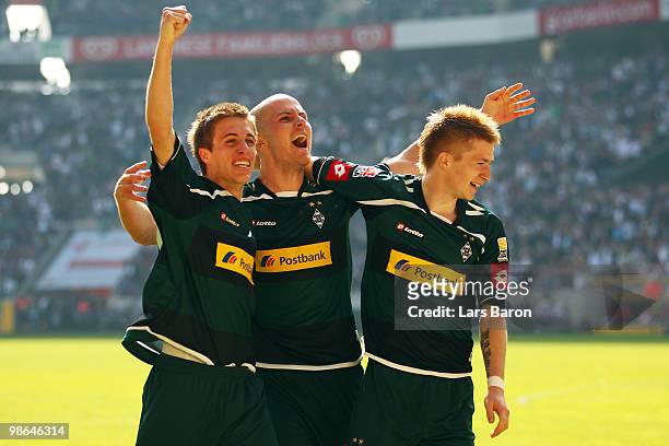 Marco Reus of Moenchengladbach celebrates scoring the first goal with team mates Patrick Herrmann and Michael Bradley during the Bundesliga match...