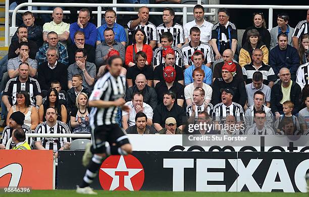 Newcastle fans shows off their spiderman masks in honour of Jonas Guitierrez who runs past during the Coca Cola Championship match between Newcastle...