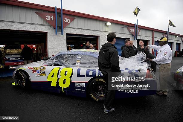 The Lowes Chevrolet crew is given instructions by a NASCAR official as all track activities are haulted at Talladega Superspeedway on April 24, 2010...