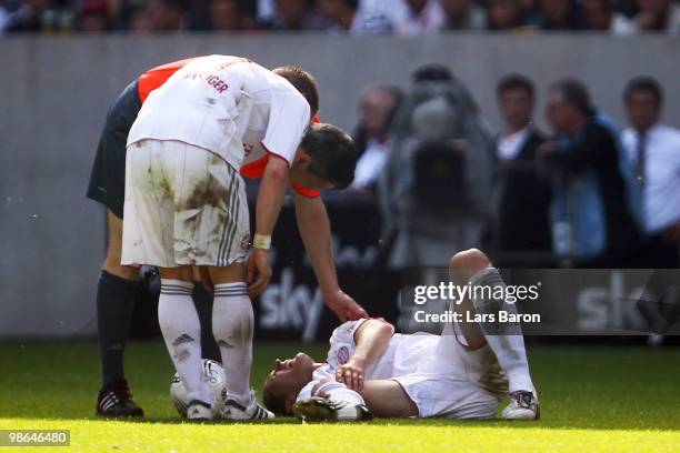 Daniel van Buyten of Muenchen lies injured on the pitch during the Bundesliga match between Borussia Moenchengladbach and FC Bayern Muenchen at...