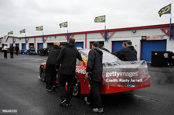 The Budweiser Ford is pushed through the garage area after all track activities are haulted due to weather at Talladega Superspeedway on April 24,...