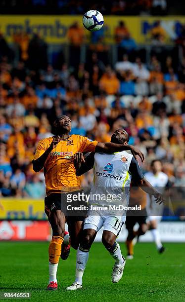 Anthony Gardner of Hull City battles with Darren Bent of Sunderland during the Barclays Premier League match between Hull City and Sunderland at the...