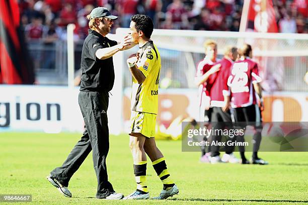 Head coach Juergen Klopp of Dortmund celebrates with Lucas Barrios after the Bundesliga match between 1. FC Nuernberg and Borussia Dortmund at the...