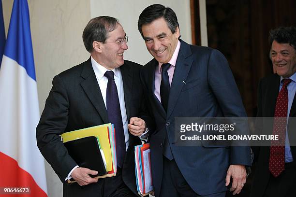 French Prime Minister Francois Fillon and Elysee palace general secretary Claude Gueant share a laugh next to Ecology minister Jean-louis Borloo...