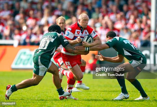 Mike Tindall of Gloucester is challenged by Elvis Seveali'i and Jonathan Joseph of London Irish during the Guinness Premiership match between...