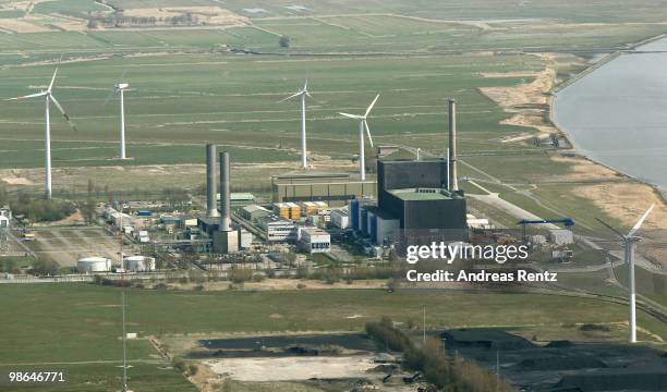 In this aerial view windmills stand near the Brunsbuettel nuclear power plant on April 24, 2010 in Brunsbuettel, Germany. Newsmakers report that...