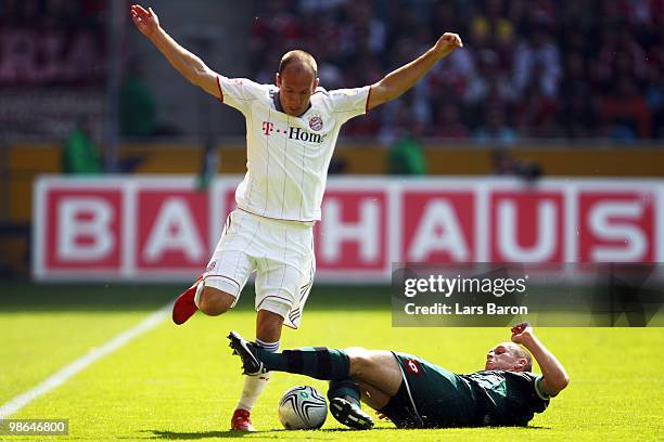 Arjen Robben of Muenchen is challenged by Filip Daems of Moenchengladbach during the Bundesliga match between Borussia Moenchengladbach and FC Bayern...