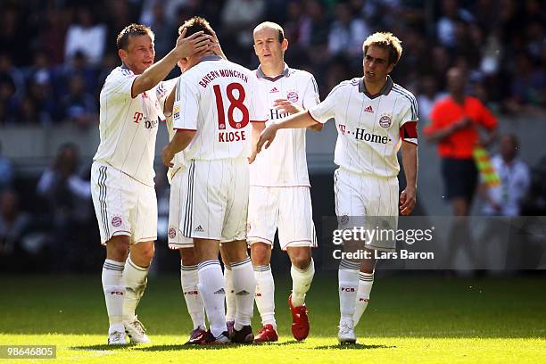 Miroslav Klose of Muenchen celebrates after scoring his first goal with team mates Ivica Olic, Arjen Robben and Philipp Lahm during the Bundesliga...