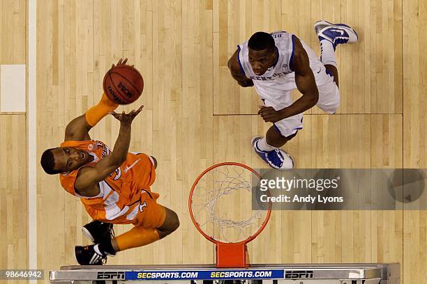 Prince of the Tennessee Volunteers dunks an alley-opp pass against Eric Bledsoe of the Kentucky Wildcats during the semirfinals of the SEC Men's...