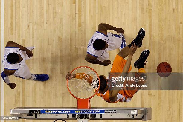 Prince of the Tennessee Volunteers dunks an alley-opp pass against Eric Bledsoe of the Kentucky Wildcats during the semirfinals of the SEC Men's...