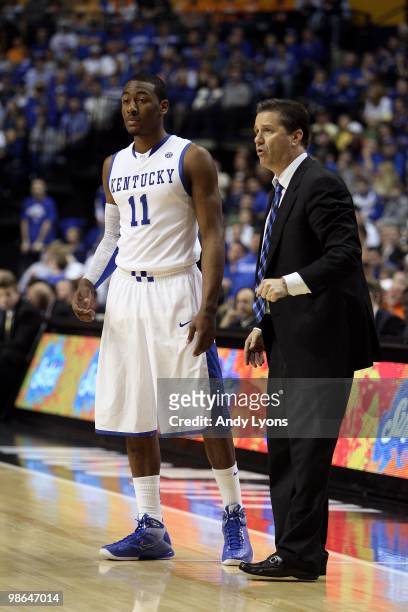 Head coach John Calipari and John Wall of the Kentucky Wildcats talk on court against the Tennessee Volunteers during the semirfinals of the SEC...