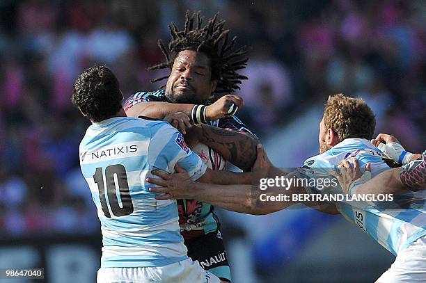 Stade Francais' centre Mathieu Bastareaud vies with Metro Racing's fly-half Jonathan Wisniewski during their French Top 14 rugby union match at the...