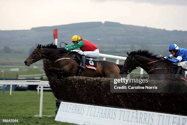 Tom Doyle riding Coolcashin jumping the last fence from Robert Power on Shuil Aris to win the Pat Taaffe Handicap Steeplechase at Punchestown...