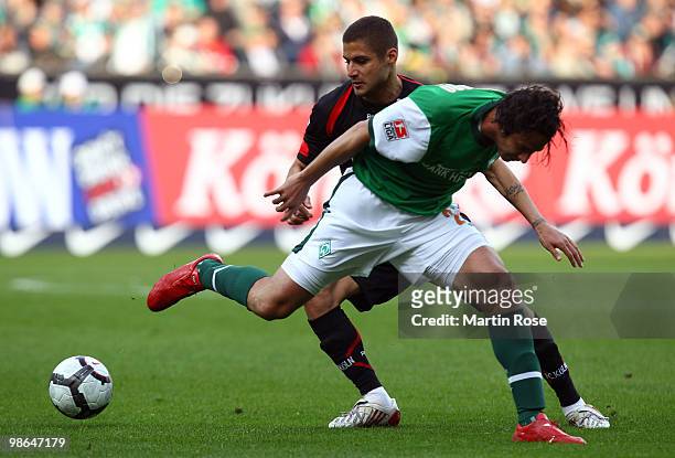 Claudio Pizarro of Bremen and Youssef Mohamad of Koeln fight for the ball during the Bundesliga match between Werder Bremen and 1. FC Koeln at Weser...