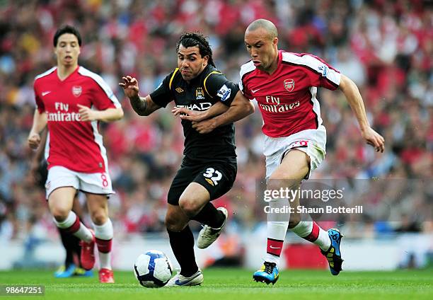 Carlos Tevez of Manchester City Mikael Silvestre of Arsenal battle for the ball during the Barclays Premier League match between Arsenal and...
