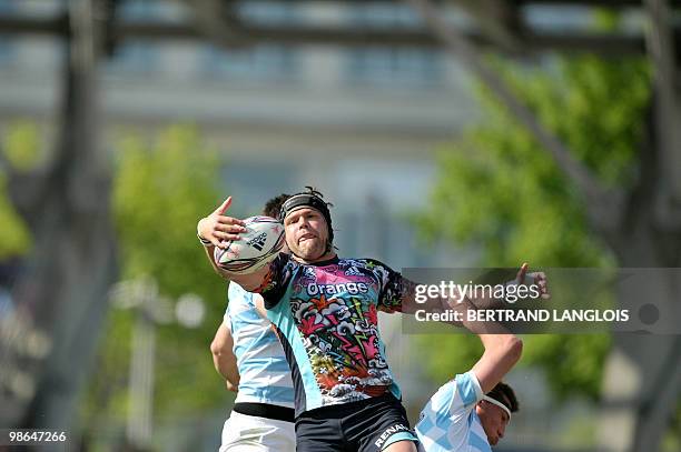 Stade Francais' lock Tom Palmer catches the ball in a line-out despite Metro Racing's players during their French Top 14 rugby union match at the...